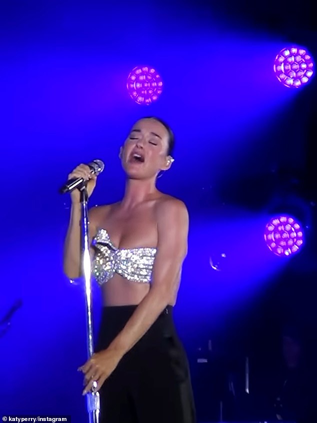 She showed off her toned arms and midriff in a glittering bandeau top and black silk pants