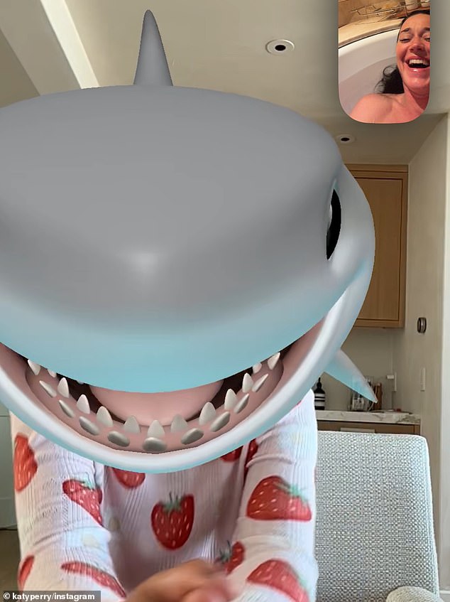 While away she FaceTimed her daughter Daisy Dove, five, while taking a bath. Perry covered Daisy's face with a shark emoji