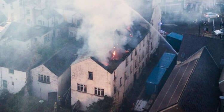 Historic Antrim hotel gutted in huge blaze as over 40 firefighters rush to battle fire with 'avoid area' warning issued