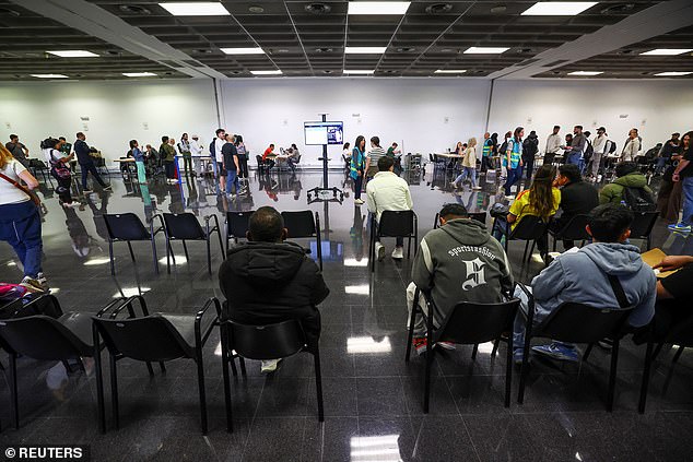 People queue to receive documentation in Hospitalet de Llobregat, near Barcelona, Spain