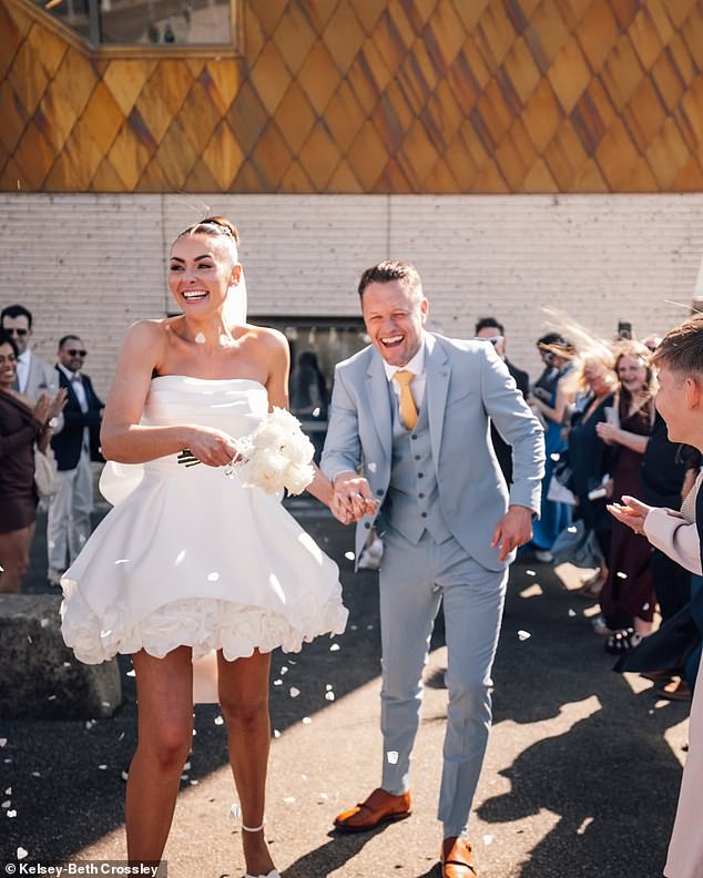 Kelsey looked sensational as she wore a bridal white strapless ruffled edged mini-dress complete with a large bow at the back