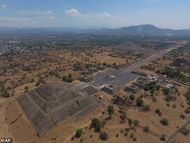 The Pyramid of the Moon, left, and the Pyramid of the Sun, back right, are seen along with smaller structures lining the Avenue of the Dead, in Teotihuacan, Mexico, March 19, 2020