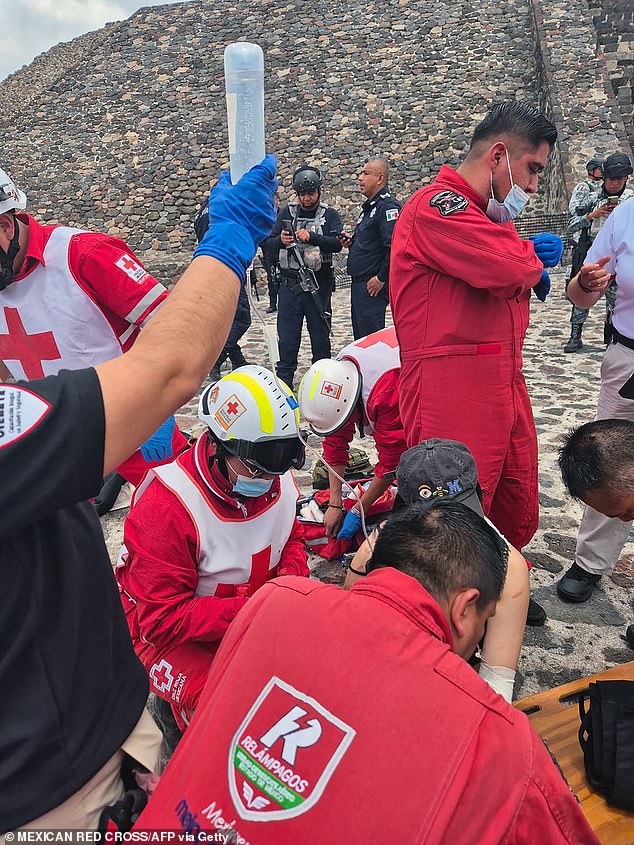 This handout picture released by Mexican Red Cross shows Mexican paramedics of the Mexican Red Cross helping to a tourist injured at the Pyramid of the Moon at the Teotihuacan archaeological zone following a shooting in Teotihuacan, State of Mexico, on April 20, 2026