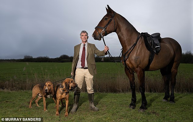 Ivan pictured with his horse, Timmy, and his bloodhounds, Disney and Sorus
