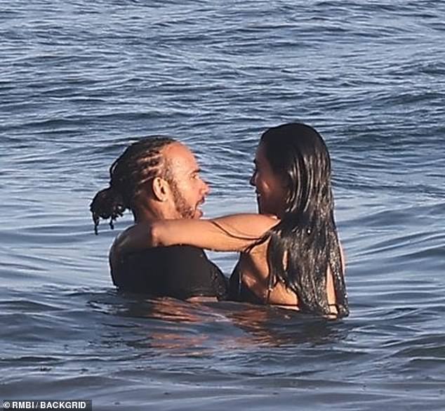 The two looked happy as they smiled at each other while in the Pacific Ocean