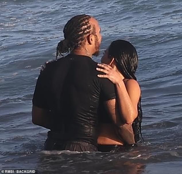 In the ocean she looked back as the waves rolled in behind her