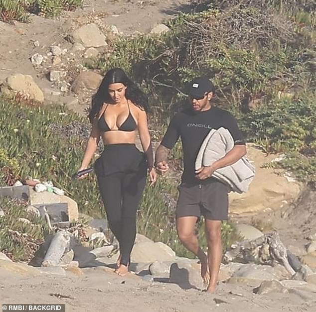 They walked side by side as they headed down to the beach with Hamilton carrying the towels