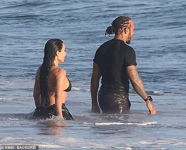 Kardashian followed the race car driver as he headed deeper into the ocean