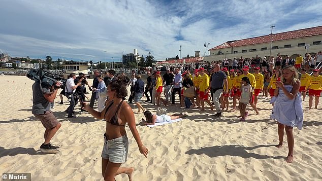 A Bondi sunbather appeared to be unaware that Harry and Meghan were just metres away