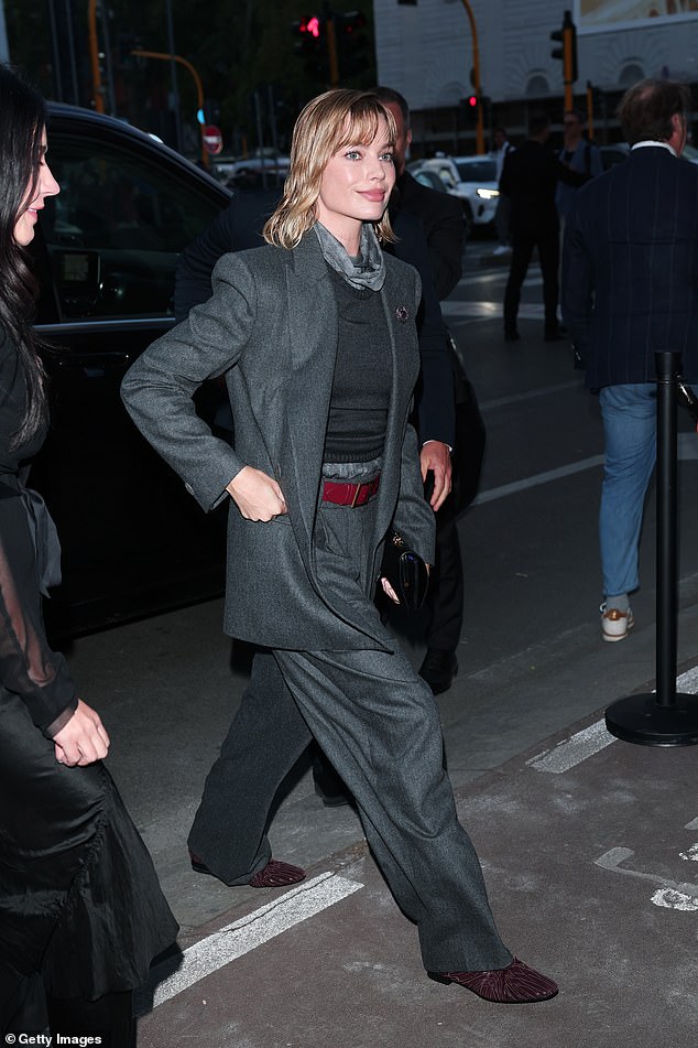Meanwhile Margot cut a smart figure in an oversized grey suit which she layered over a roll neck jumper