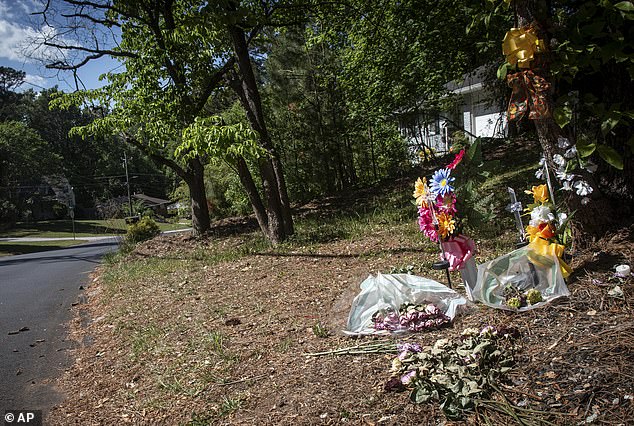 Flowers lay on the ground near the site where Lauren Bullis was killed, in Decatur