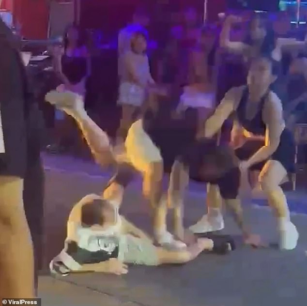 They allegedly hurled verbal abuse and called him a 'little c***' before the violence erupted in the neon-lit nightlife strip of Soi Buakhao