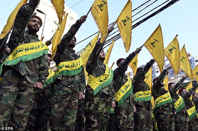 Hezbollah fighters attend the funeral of three Hezbollah commanders who died in an Israeli strike on a southern suburb of Beirut in 2024
