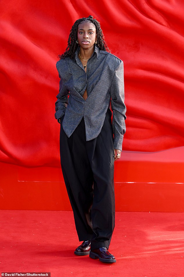 Cat Burns wore a grey suit jacket and baggy black trousers