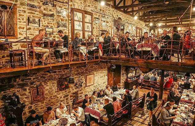 At Tradita Geg & Tosk, guests can tuck into tavë kosi - a hearty lamb-based dish cooked with rice and yoghurt - in a cosy setting