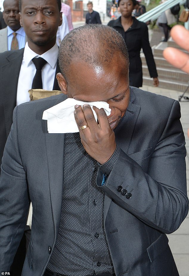Eric Adusah cries as he leaves an inquest into his wife's death in Chelmsford, Essex, in 2016