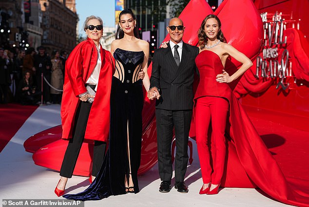 The actress has been promoting her role in the sequel, and slipped into a skintight velvet dress while posing with co-stars Meryl Streep, Stanley Tucci and Emily Blunt on the red carpet