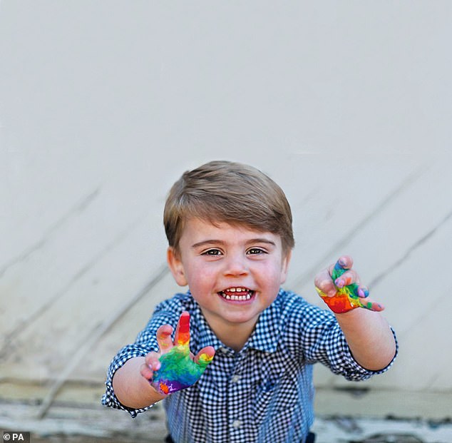 Dressed in a blue checked shirt, Louis looked positively ecstatic to be creating rainbow-coloured handprints as his parents tried to keep him busy after the world went into lockdown