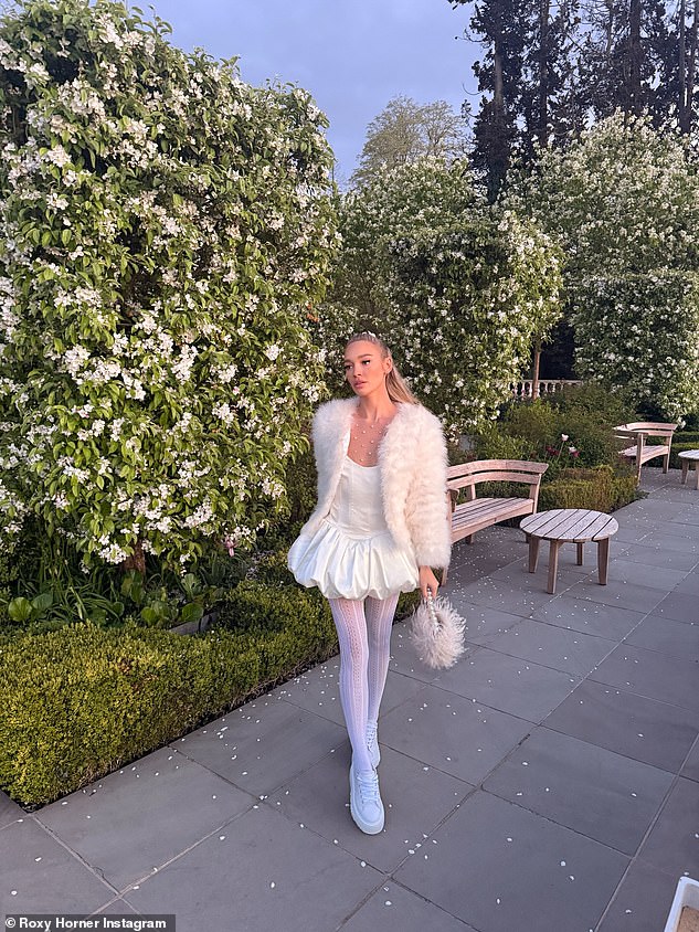 The photos show the model holding onto the bridal white theme, as she roamed Coworth Park's gardens in a puffball-skirted mini dress teamed with lace tights and trainers