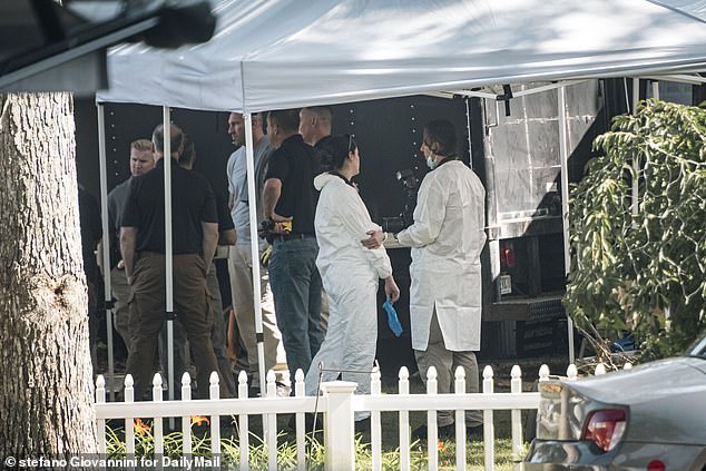 Forensic teams  and investigators moving out troves of evidence from Heuermann's home