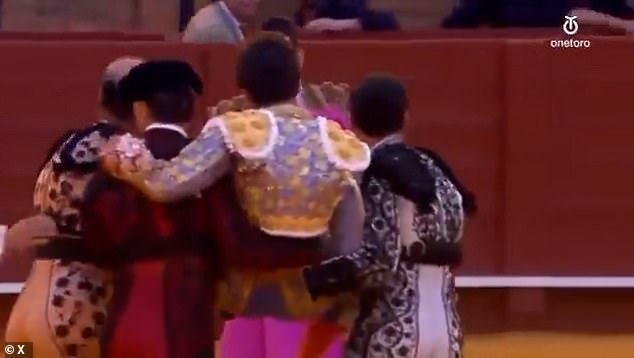 Several bullfighting assistants, known in Spanish as 'cuadrillas', stepped in to draw the raging animal's attention away from Rey