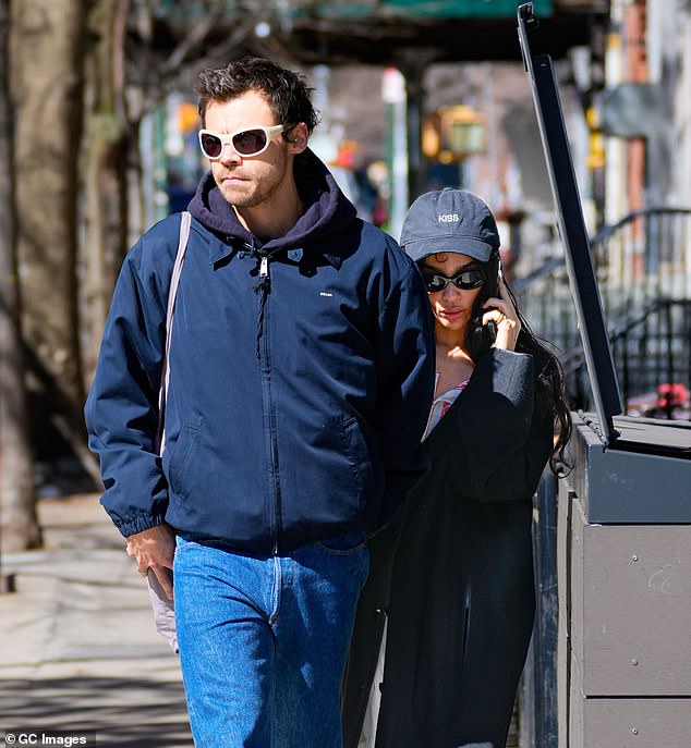 The Batman star, 37, was seen for the first time since news broke as she stepped out in NYC on Friday after previously being spotted wearing a diamond ring  (pictured with Harry last mont
