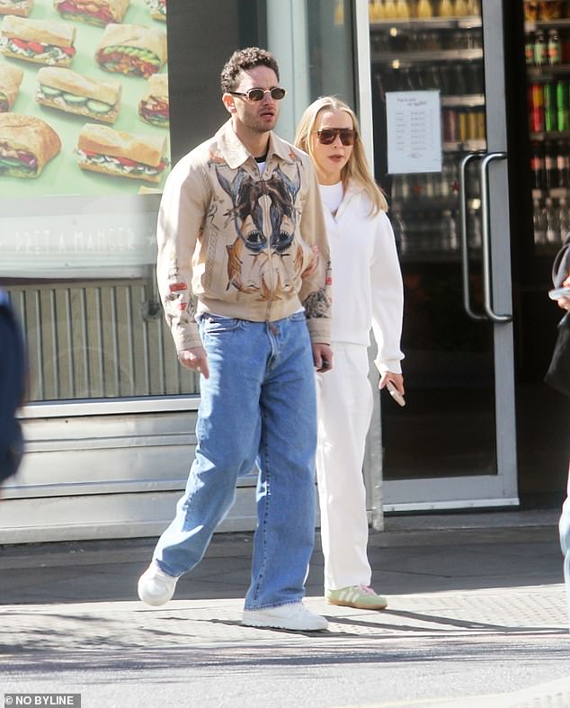 As the interview aired, Adam was seen out in London with his wife Caroline, with the pair looking tense on their outing