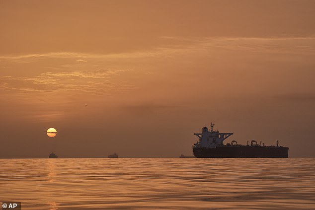 The closing of the strait has plunged the world into an energy crisis as tankers carrying a fifth of the world's oil have been blocked from using the channel. Pictured: The sun rises behind tankers anchored in the Strait of Hormuz off the coast of Qeshm Island, Iran, Saturday, April 18, 2026