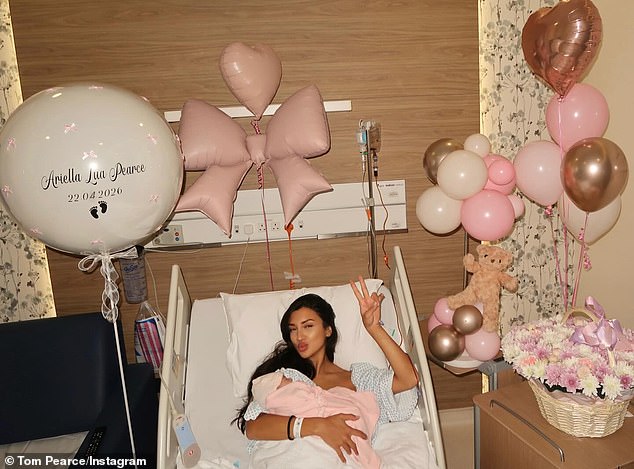 In another photo, his wife, who's name is unknown, laid in a hospital bed surrounded by pink balloons