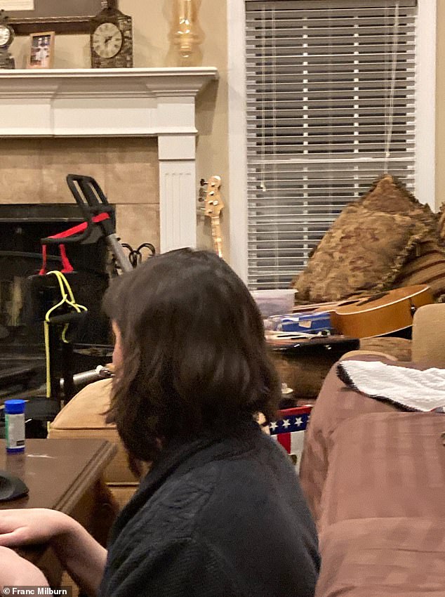 Milburn shared a picture he said showed Eskridge sitting in her home - near the window which she claimed was scorched by an 'energy weapon'