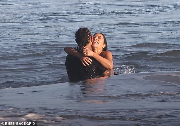The pair appeared not to notice the photographer stationed metres from the beach