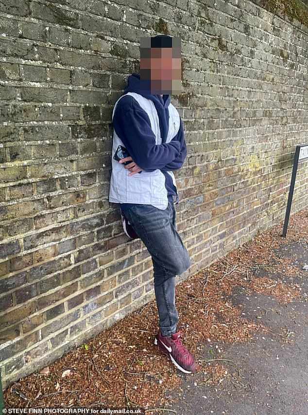 An Afghan asylum seeker leans against a wall in Laleham. He was later arrested and detained under the Mental Health Act after reportedly approaching female pupils and becoming aggressive when spoken to