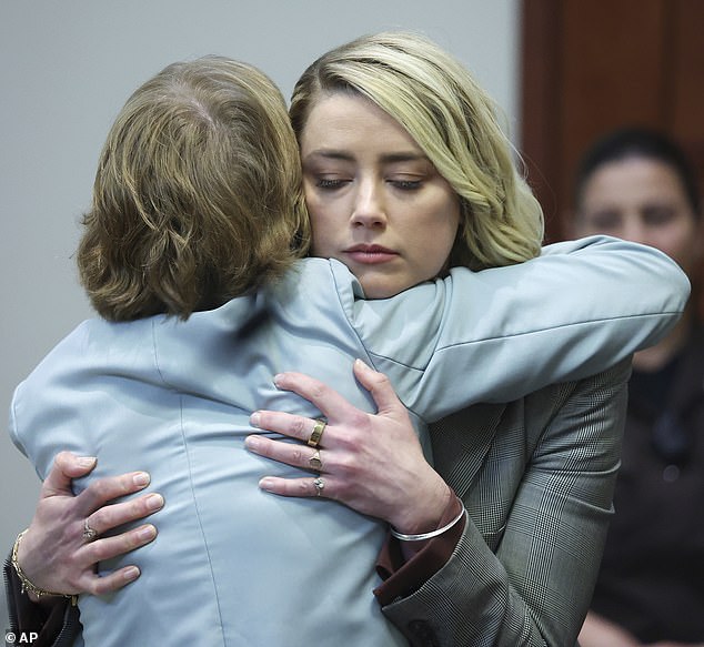 Heard hugs her attorney Elaine Bredehoft after she testified in the courtroom in 2022