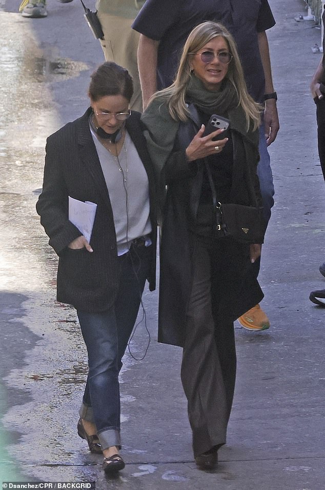 The 57-year-old actress was bundled up in a warm coat and scarf and holding her cell phone at another point during the day