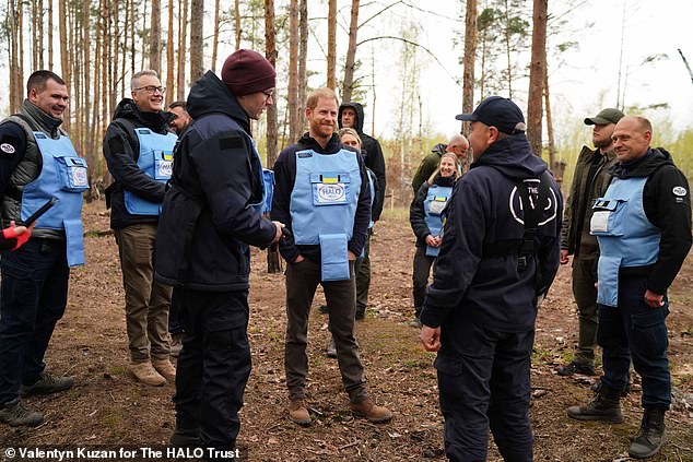 Here he is pictured speaking with staff from the landmine clearance charity HALO in Bucha