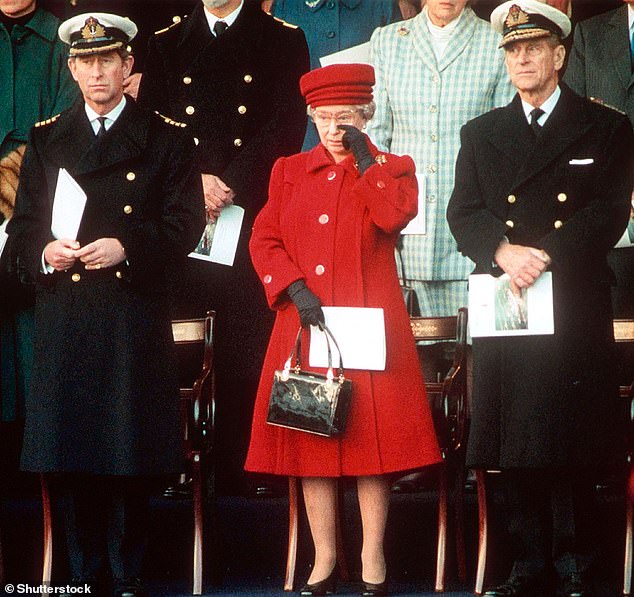 An emotive image of Queen Elizabeth, dressed in pillar box red with Prince Philip and the future king by her side at the 1997 decommissioning ceremony of Britannia