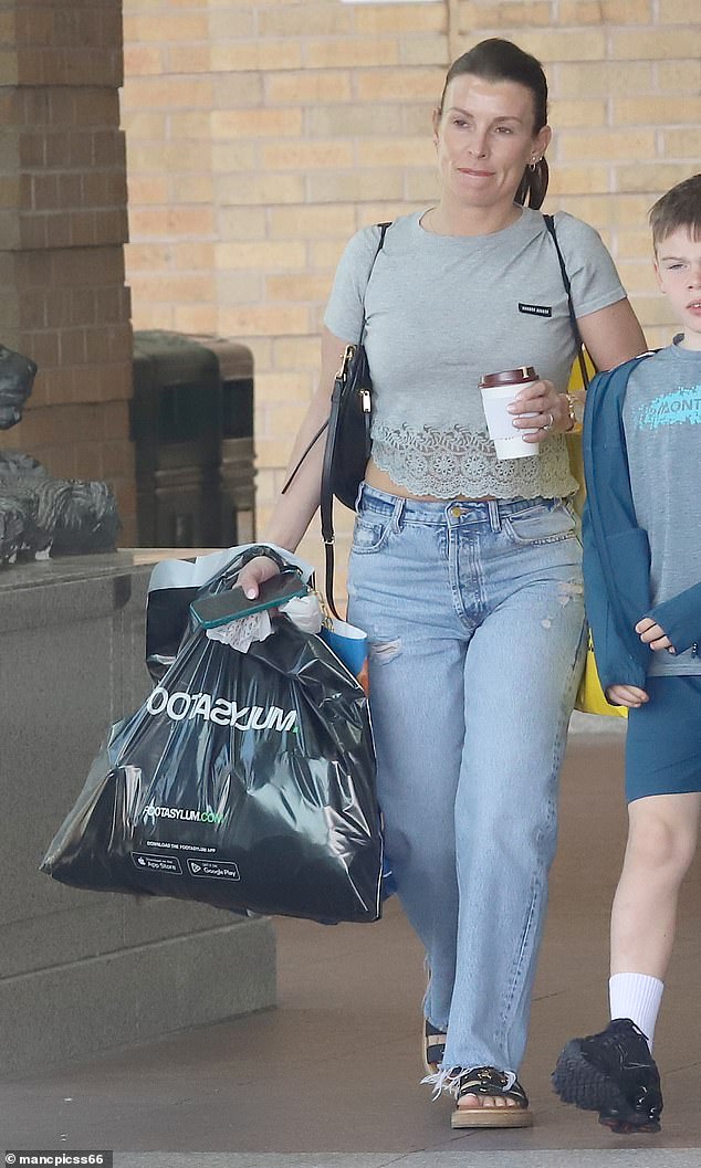 As she walked to her £250,000 Range Rover, Coleen carried bulging bags from Footasylum and Selfridges