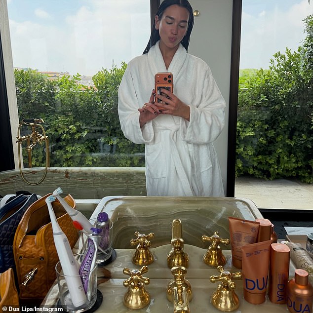 In another snap she was seen posing for a mirror selfie in a luxurious white robe as she did her skincare routine