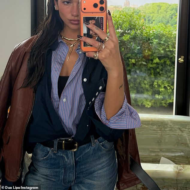 She also posed wearing a red leather jacket with a blue striped shirt, jeans and an array of gold chunky jewellery