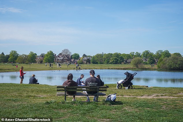 City dwellers sprawled across Wimbledon Common, southwest London, as temperatures reached highs of 22C