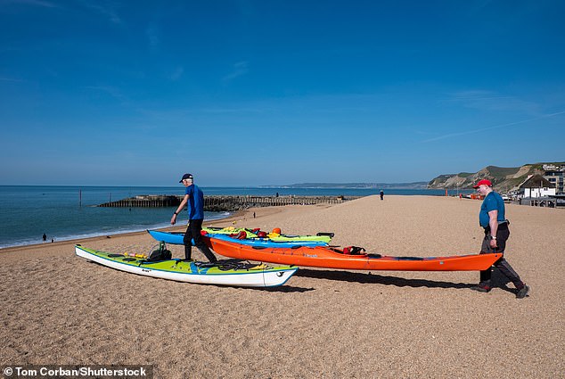 Sea kayakers made the most of the good weather as they prepared to take to the water at West Bay on Dorset's Jurassic Coast