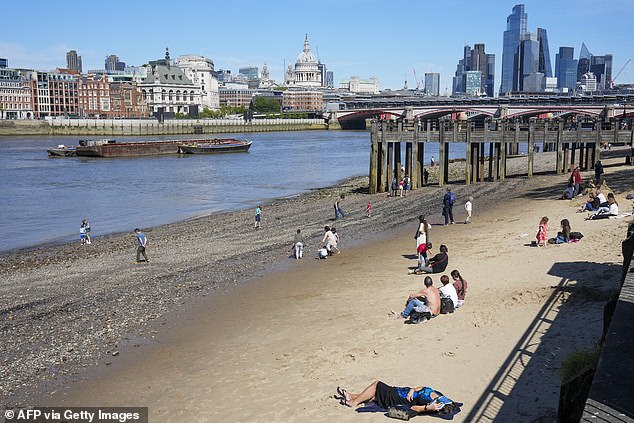 Londoners enjoyed the weather on the southern bank of the River Thames, as they looked out on to the City of London on Saturday