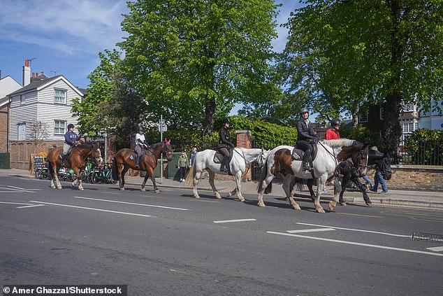 Horse riders passed through Wimbledon village in the sunshine on Saturday