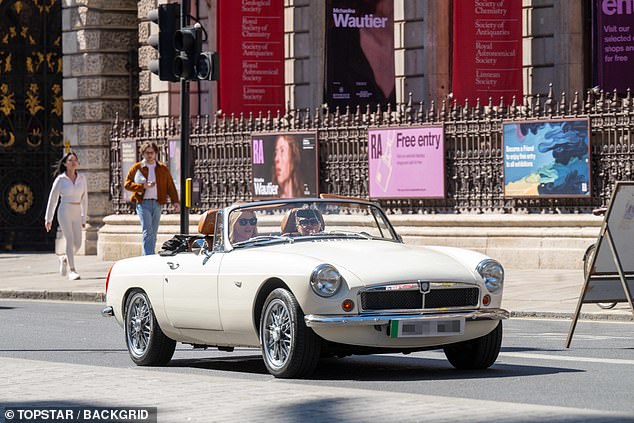 The British model, known to be a fan of vintage cars, drove down Piccadilly with a friend in the passenger seat