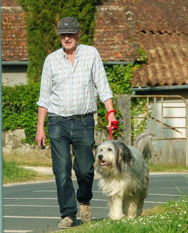 Karen's lover Jean-Francois Guerrier with her dog. He had been the first to be arrested after he found Karen dying on her driveway minutes after she was attacked