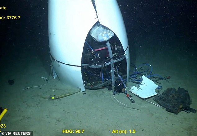 At one point in the search and rescue operation, operators realised the sub must have collapsed inwards within a fraction of a second, killing all five men instantaneously. Pictured: Coastguard footage of the debris of the submersible