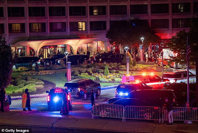 Law enforcement surrounds the Washington Hilton Hotel where shots were fired