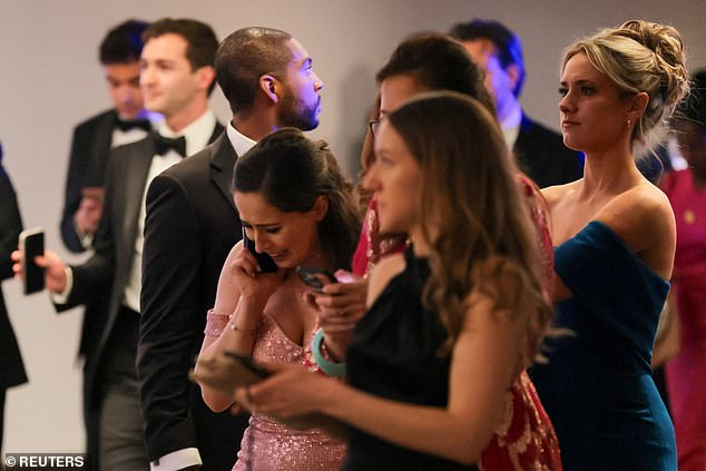 A frantic guest makes a phone call shortly after being evacuated from the ballroom