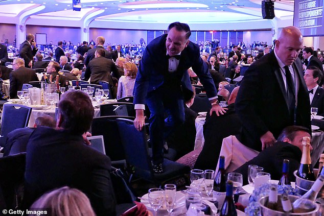 White House Deputy Chief of staff Dan Scavino leaps over a chair amid the chaos