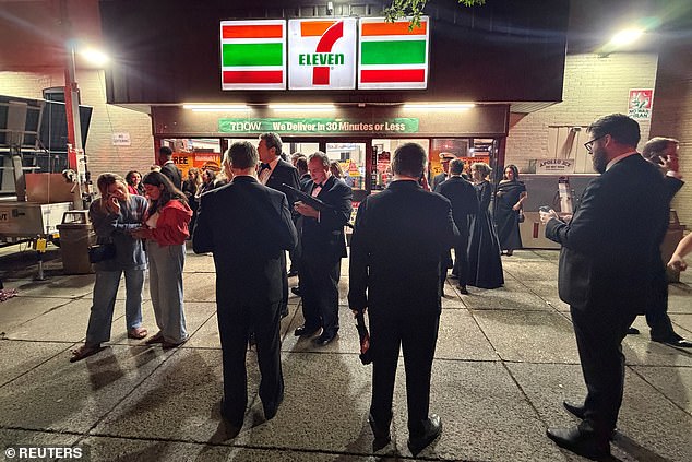 Guests congregate outside of a Washington DC 7-Eleven following the shooting. All of the guests were evacuated and the dinner was postponed